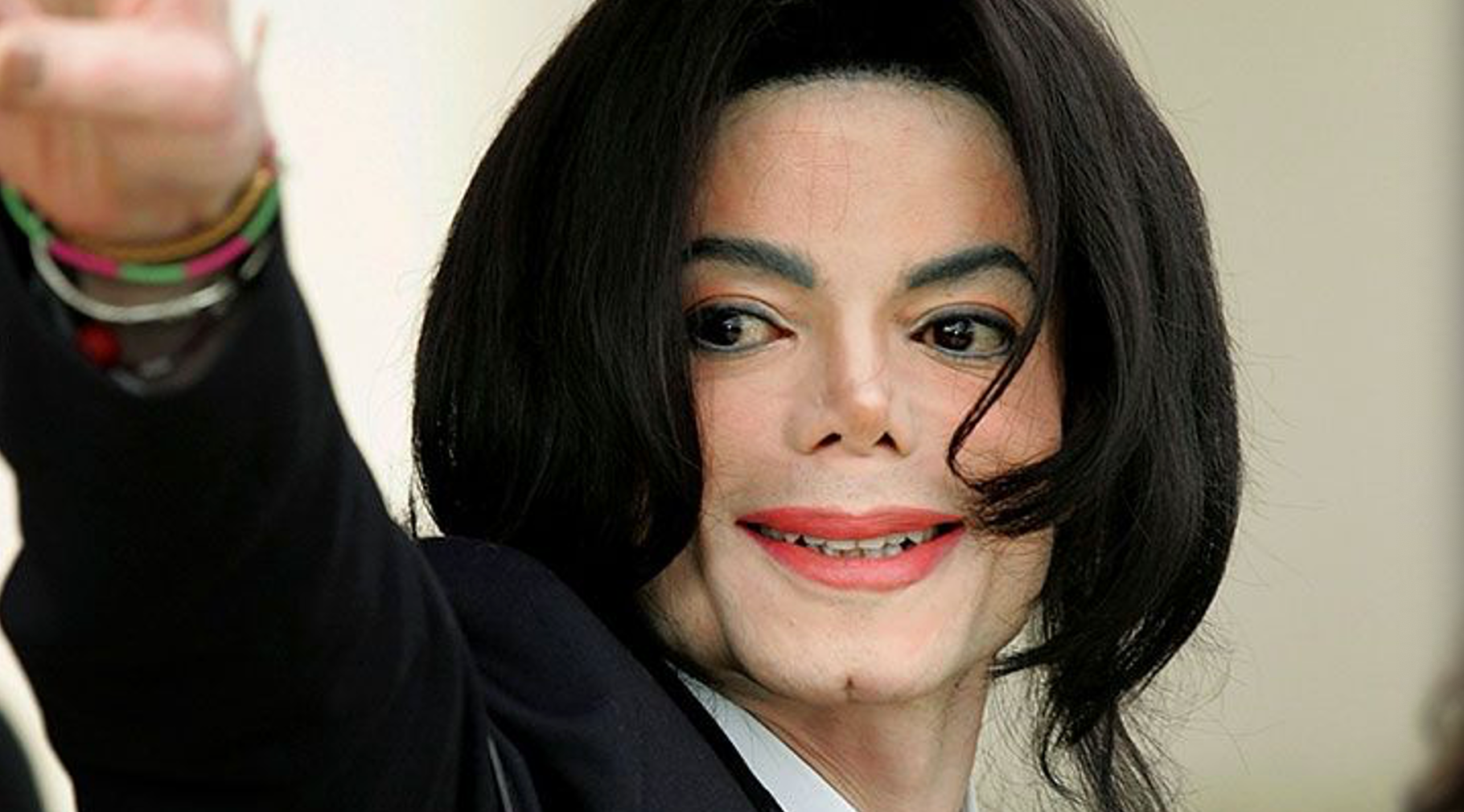 Close-up of smiling Michael Jackson who is probably waving to his fans