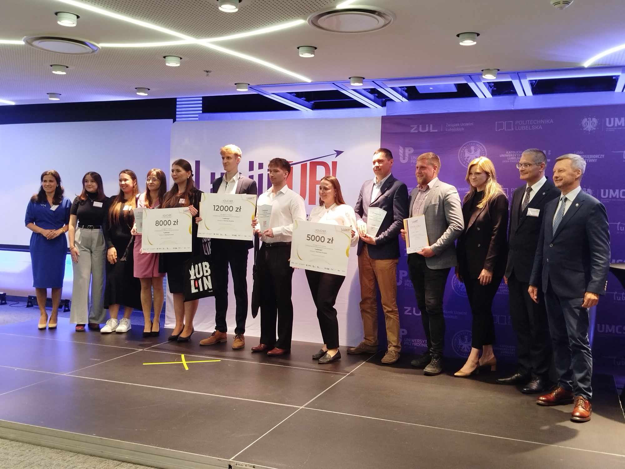 Laureaci III edycji konkursu LublinUp! pozują z nagrodami i koordynatorami uczelnianymi